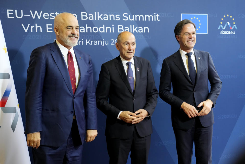 Albanian Prime Minister Edi Rama, left, and Dutch Prime Minister Mark Rutte, right, are greeted by Slovenia's Prime Minister Janez Jansa during arrivals for an EU summit at the Brdo Congress Center in Kranj, Slovenia, Wednesday, Oct. 6, 2021. European Union leaders are gathering Wednesday to reassure six countries in the Balkans region that they could join the trading bloc one day if they can meet its standards but are unlikely to give any signal even about when they might advance in their quests. (AP Photo/Darko Bandic)
