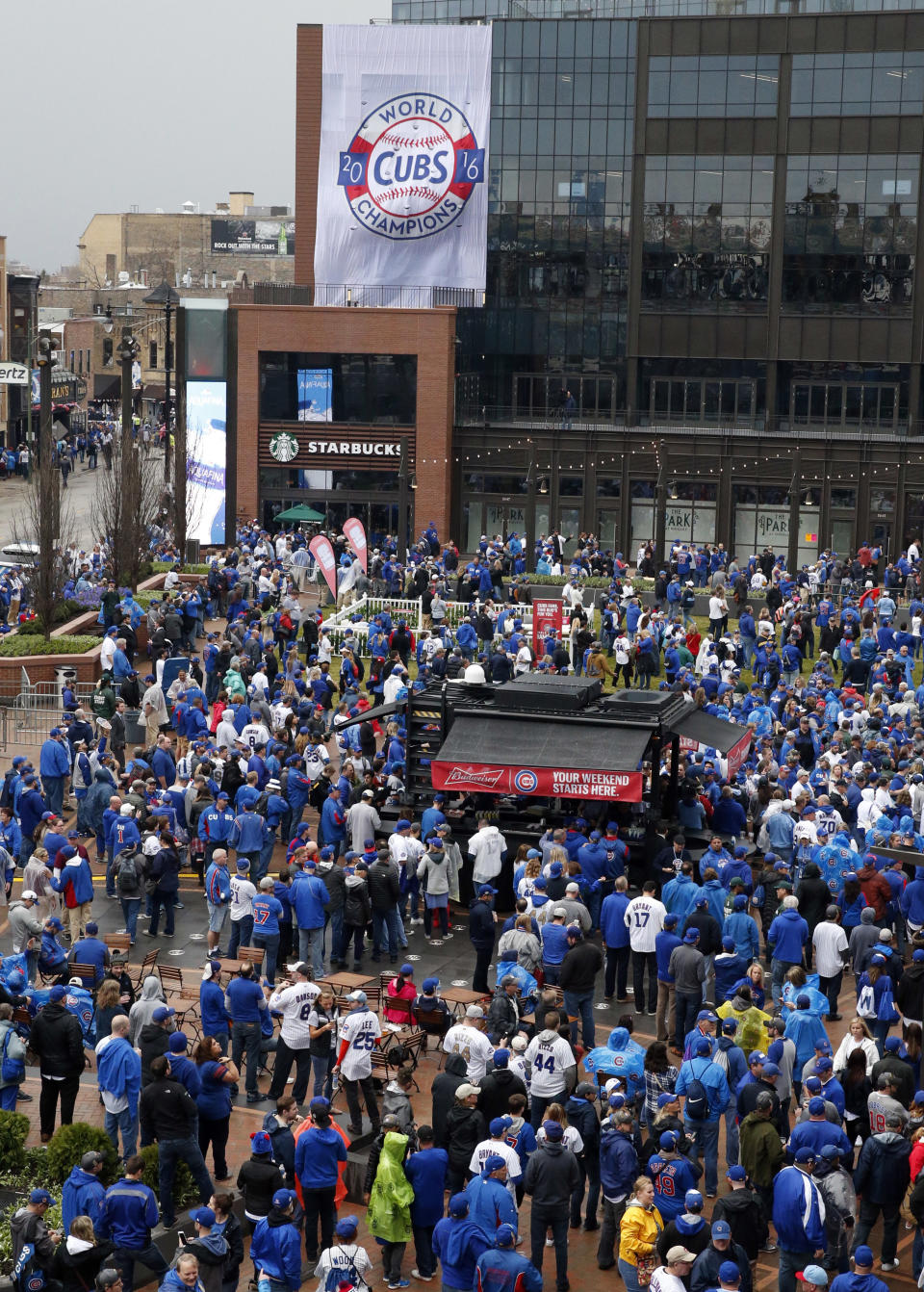Fans gather outside in the Park at Wrigley before a baseball game between the Chicago Cubs and the Los Angeles Dodgers on home opening day, Monday, April 10, 2017, in Chicago. (AP Photo/Nam Y. Huh)