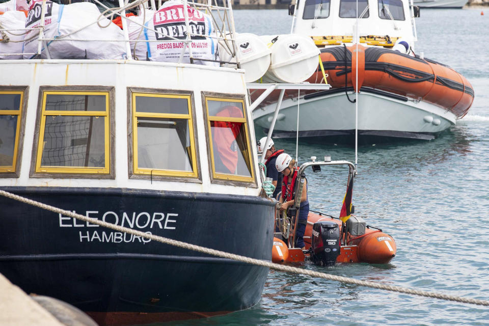 Personnel work next to the German rescue boat Eleonore as it docks in the port of Pozzallo, Sicily, Southern Italy, Monday, Sept. 2, 2019. Italy’s interior minister is vowing to make the charity boat with some 100 rescued migrants aboard pay dearly for docking in Sicily in defiance of a government ban. (Francesco Ruta/ANSA via AP)