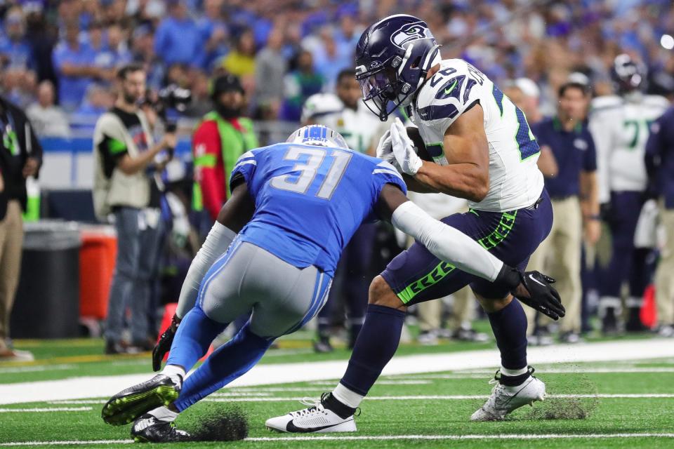 Detroit Lions safety Kerby Joseph (31) tackles against Seattle Seahawks running back Zach Charbonnet (26) during the second half at Ford Field in Detroit on Sunday, Sept. 17, 2023.