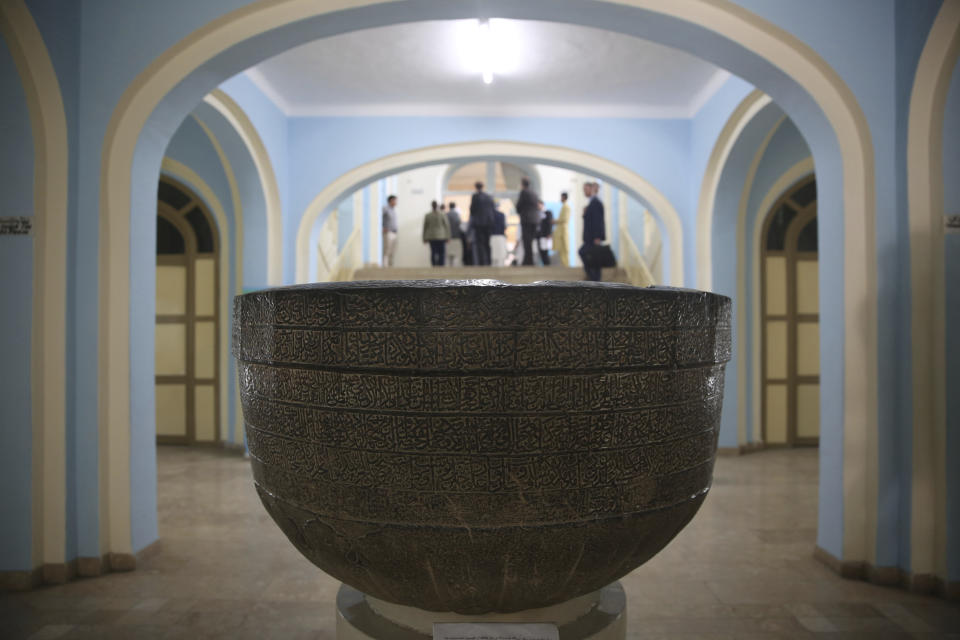 In this Saturday, Aug. 17, 2019 photo, a gray marble basin with Islamic calligraphy inscriptions from the 16th century is on display at the National Museum of Afghanistan in Kabul, Afghanistan, Saturday, Aug. 17, 2019. The Taliban fighters arrived with hammers and hatred. Fragments of what they left behind have been laid out on tables at the National Museum of Afghanistan, 18 years later: shattered pieces of ancient Buddha figurines smashed because they were judged to be against Islam. (AP Photo/Rafiq Maqbool)