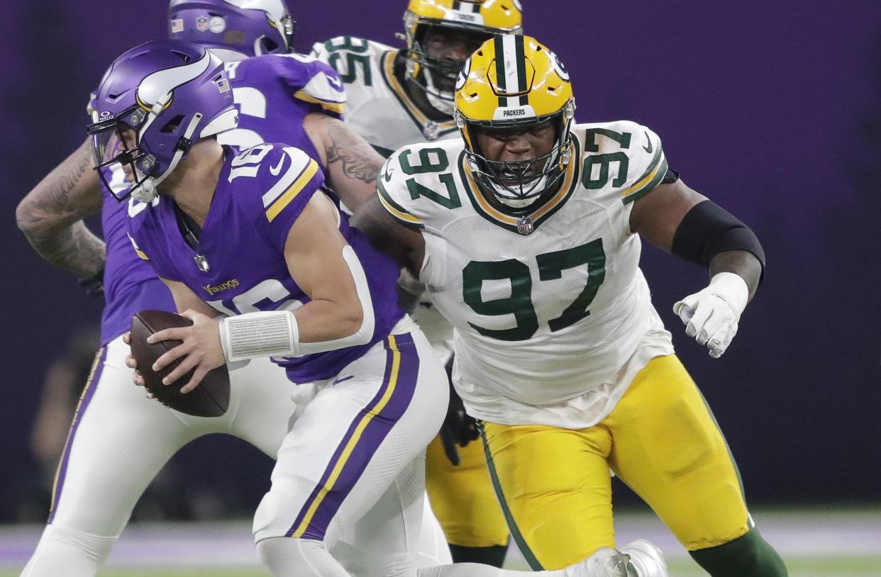 Dec 31, 2023; Minneapolis, Minnesota, USA; Green Bay Packers defensive tackle Kenny Clark (97) pressures Minnesota Vikings quarterback Jaren Hall (16) during their game at U.S. Bank Stadium. Mandatory Credit: Dan Powers-USA TODAY Sports