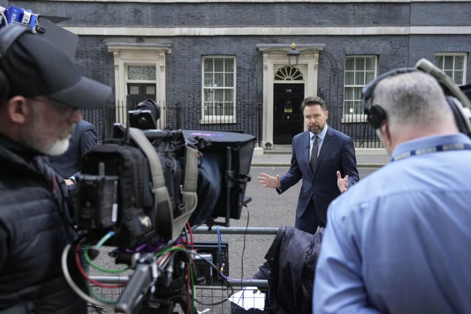 Journalists wait opposite 10 Downing Street in London, Wednesday, July 6, 2022. Treasury chief Rishi Sunak and Health Secretary Savid Javid resigned within minutes of each other, costing British Prime Minister Boris Johnson the support of the men responsible for tackling two of the biggest issues facing Britain — the cost-of-living crisis and surging COVID-19 infections. (AP Photo/Frank Augstein)