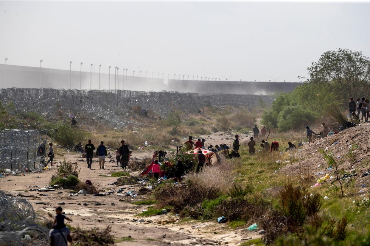 Migrants walk in the dry bed of the Rio Grande between Ciudad Juárez, Mexico, and El Paso, Texas on April 25, 2024. Despite the increased infrastructure put in place by the Texas National Guard migrants who can make it to Mexico's northern border have been able to break the concertina wire in hopes of turning themselves to Border Patrol for processing.