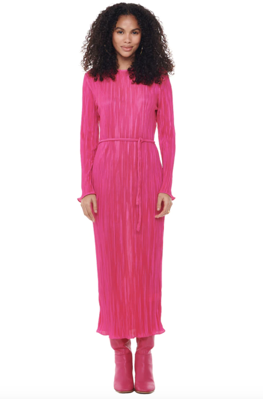 model with long curly hair wearing hot pink boots and hot pink long sleeve midi dress, Pink Plisse Dress (Photo via Never Fully Dressed)