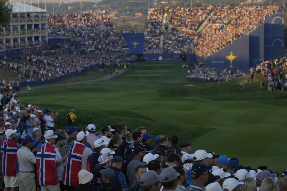 Fans line the 1st hole as they wait for the start of the morning Foursome match at the Ryder Cup golf tournament at the Marco Simone Golf Club in Guidonia Montecelio, Italy, Friday, Sept. 29, 2023. (AP Photo/Alessandra Tarantino)