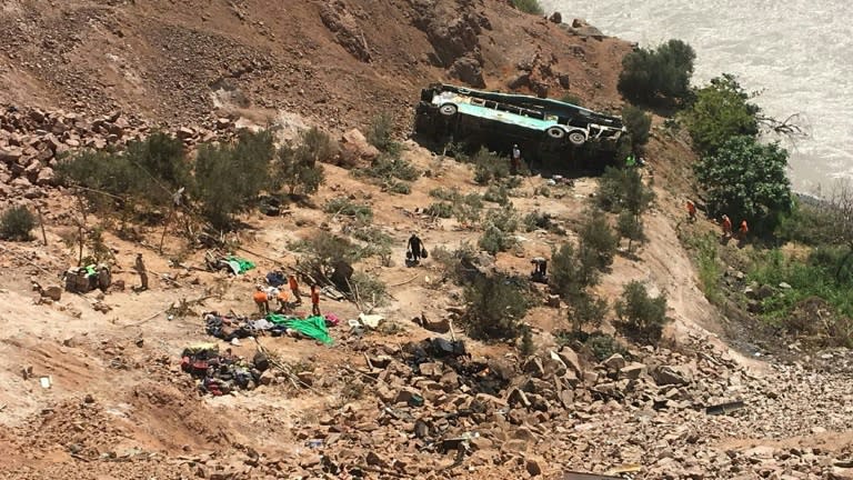 A bus that went off the Panamerican highway in southern Peru, killing at least 35, is seen resting at the bottom of a steep slope