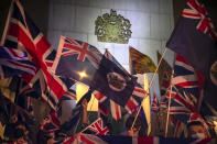 Demonstrators wave British and Hong Kong colonial flags during a rally outside of the British Consulate in Hong Kong, Wednesday, Oct. 23, 2019. Some hundreds of Hong Kong pro-democracy demonstrators have formed a human chain at the British consulate to rally support for their cause from the city's former colonial ruler. (AP Photo/Mark Schiefelbein)