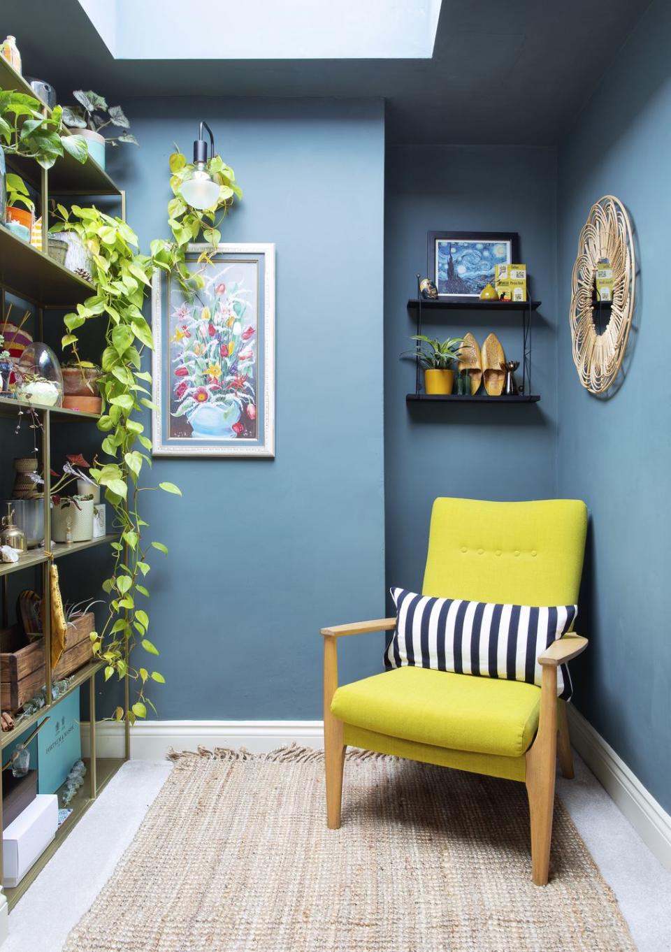 a zesty lime green chair pops against a deep teal wall on the landing