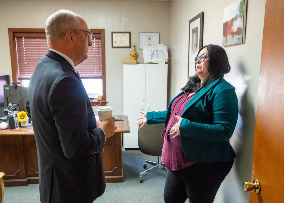 Faith House survivor advocate Tiffany Decou meets with Louisiana Gov. John Bel Edwards during his visit Monday to discuss a recent government grant. The governor's visit is part of a statewide tour marking the five-year anniversary of his criminal justice reform.