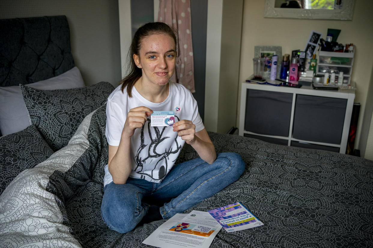 Maisy Byrne, aged 16, a student at Liverpool Community College holds her Covid-19 Vaccine card after having her first Pfizer dose of the vaccine at Hope University, Liverpool. Picture date: Friday September 3, 2021. (Photo by Peter Byrne/PA Images via Getty Images)