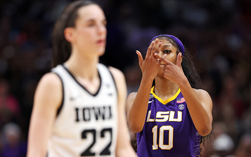 Angel Reese #10 of the LSU Lady Tigers reacts toward Caitlin Clark #22 of the Iowa Hawkeyes