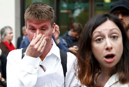 Lauri Love (L) reacts as he leaves after attending his extradition hearing at Westminster Magistrates' Court in London, Britain September 16, 2016. REUTERS/Peter Nicholls