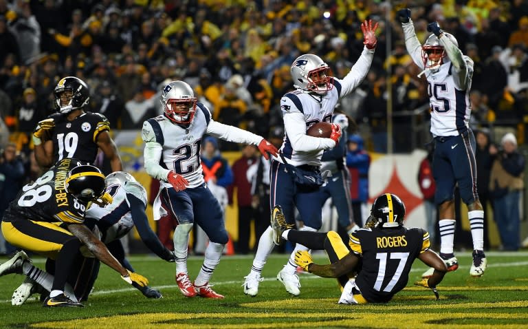 Duron Harmon (C) of the New England Patriots intercepts a pass thrown by Ben Roethlisberger of the Pittsburgh Steelers with five seconds left to play in the fourth quarter at Heinz Field