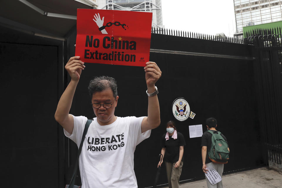 A protester holds up a placard outside the U.S. Consulate in Hong Kong, Wednesday, June 26, 2019. Hong Kong activists opposed to contentious extradition legislation on Wednesday called on leaders of the U.S., the European Union and others to raise the issue with Chinese President Xi Jinping at this week's G-20 summit in Japan. (AP Photo/Kin Cheung)