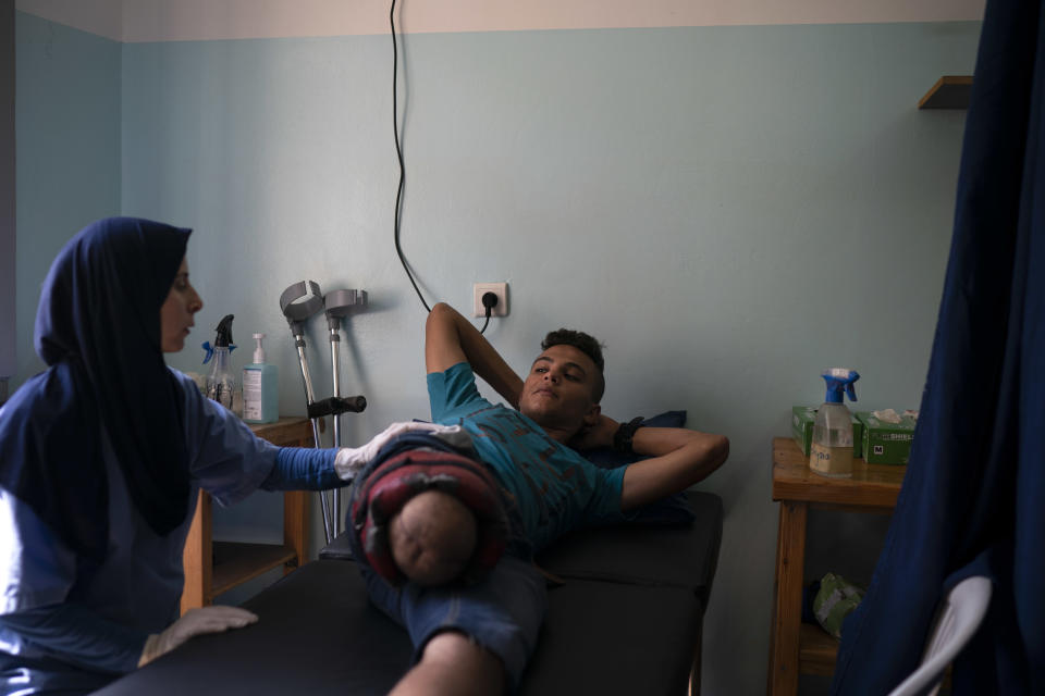 In this Sept. 10, 2018, photo, 18-year-old Atalla Fayoumi, who had his leg amputated after he was shot in a demonstration in April, attends a physical therapy session in a clinic run by MSF (Doctors Without Borders) in Gaza City. Ever since Hamas launched demonstrations in March against Israel's blockade of Gaza, children have been a constant presence in the crowds. Since then, U.N. figures show that 948 children under 18 have been shot by Israeli forces and 2,295 have been hospitalized, including 17 who have had a limb amputated. (AP Photo/Felipe Dana)