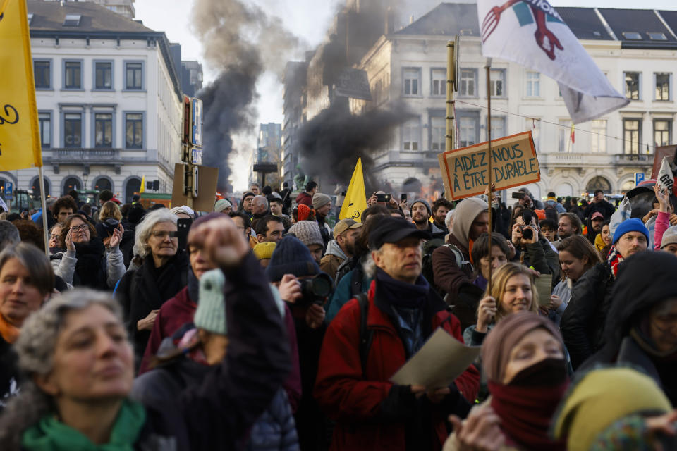 People shout slogans during a protest by farmers outside the European Parliament as European leaders meet for an EU summit in Brussels, Thursday, Feb. 1, 2024. European Union leaders meet in Brussels for a one day summit to discuss the revision of the Multiannual Financial Framework 2021-2027, including support for Ukraine. The board on the right reads in French: "Help us to be sustainable". (AP Photo/Thomas Padilla)