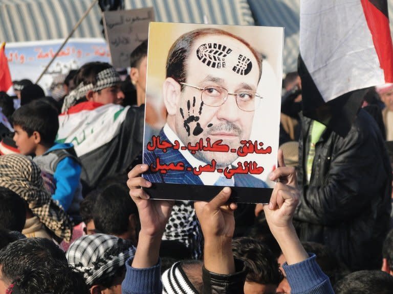 Iraqi Sunni protestors hold up a portrait of Prime Minister Nuri al-Maliki at a rally near Ramadi on Friday. Thousands of Sunnis demonstrated across Iraq on Friday, in the latest of nearly two weeks of rallies criticising the country's premier and demanding the release of prisoners they say are wrongfully held