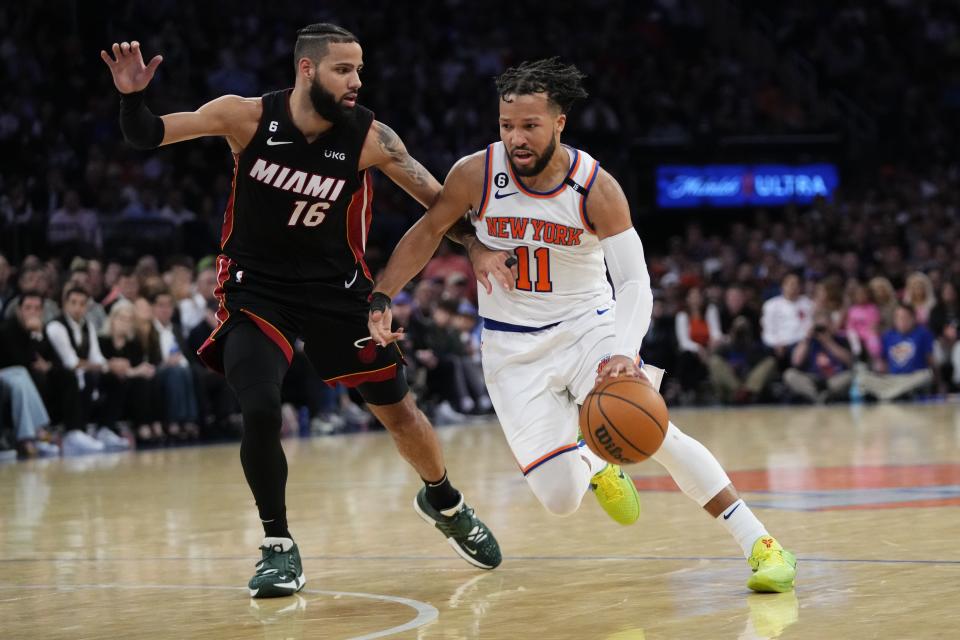 New York Knicks' Jalen Brunson (11) drives past Miami Heat's Caleb Martin (16) during the second half of Game 5 of the NBA basketball Eastern Conference playoff semifinal Wednesday, May 10, 2023, in New York. The Knicks won 112-103. (AP Photo/Frank Franklin II)