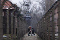 People visit the former Nazi German concentration and extermination camp Auschwitz-Birkenau in Oswiecim, Poland, Thursday, Jan. 26, 2023. Survivors of Auschwitz-Birkenau are gathering to commemorate the 78th anniversary of the liberation of the Nazi German death camp in the final months of World War II, amid horror that yet another war has shattered the peace in Europe. The camp was liberated by Soviet troops on Jan. 27, 1945. (AP Photo/Michal Dyjuk)