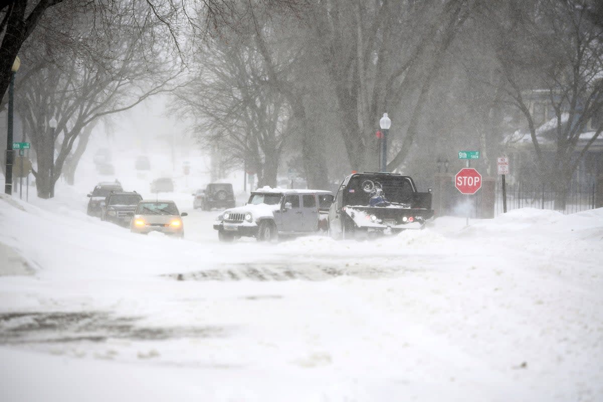 Vehicles are stuck during a snowstorm on Wednesday, Feb. 22, 2023, in Sioux Falls, S.D.  A brutal winter storm knocked out power in California, closed interstate highways from Arizona to Wyoming and prompted more than 1,200 flight cancellations Wednesday and the worst won't be over for several days. (Erin Woodiel /The Argus Leader via AP) (AP)