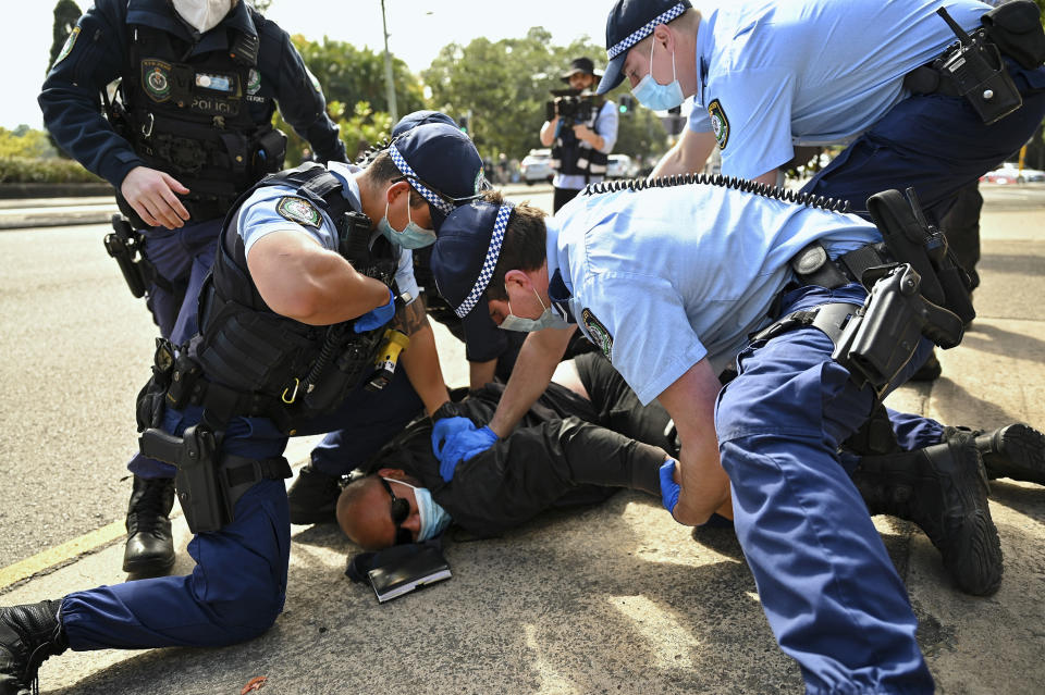 Police arrest a man during an anti-lockdown protest in Sydney, Australia, Saturday, Aug. 21, 2021. Protesters are rallying against government restrictions placed in an effort to reduce the COVID-19 outbreak. (Steven Saphore/AAP Image via AP)