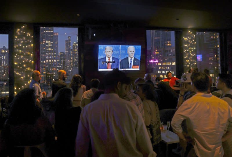 Visitors to a rooftop bar in Times Square watch the CNN presidential debate between President Joe Biden and former President Donald Trump in New York on Thursday. Photo by John Angelillo/UPI