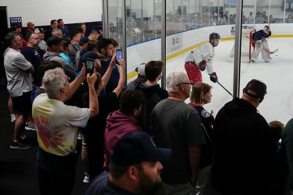 Jul 2, 2023; Columbus, Ohio, USA;  Fans watch as forward Adam Fantilli (11) controls the puck during the Columbus Blue Jackets development camp at the OhioHealth Chiller North in Lewis Center. 