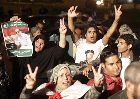 People celebrate after Egypt's army chief Field Marshal Abdel Fattah al-Sisi declared his candidacy for a presidential election, in Tahrir square in Cairo March 26, 2014. REUTERS/Asmaa Waguih