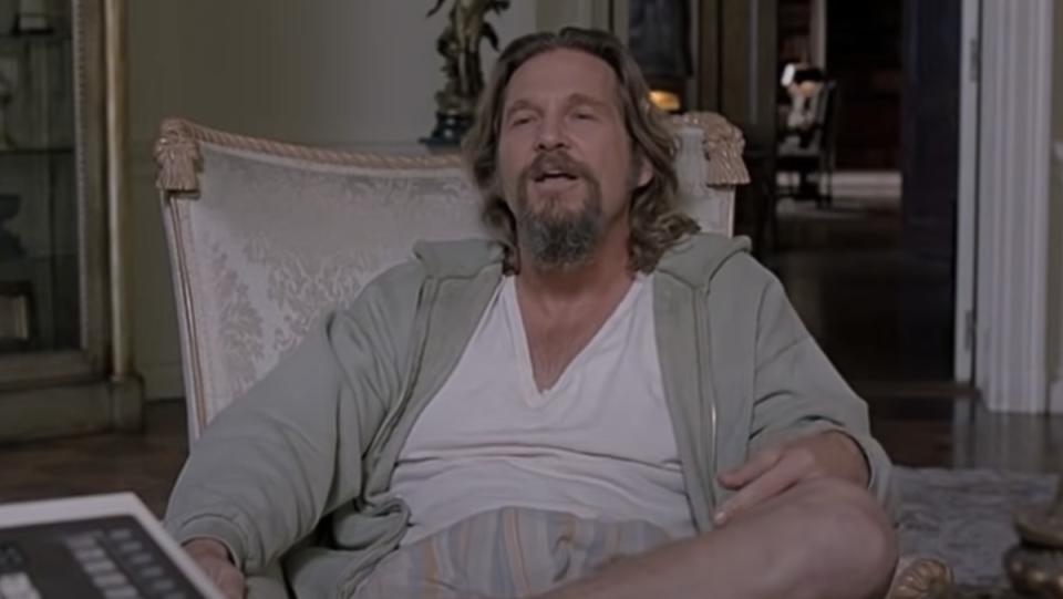 Jeff Bridges as the Dude sitting in a chair in The Big Lebowski
