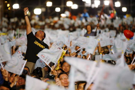 A supporter of Democratic Progressive Party (DPP) Chairperson and presidential candidate Tsai Ing-wen celebrates to preliminary results at their party headquarters in Taipei, Taiwan January 16, 2016. REUTERS/Damir Sagolj