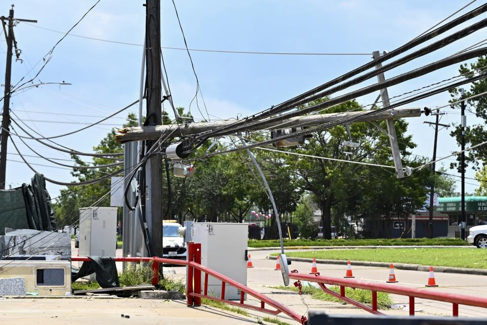 Utility poles damaged by Hurricane Beryl await repairs in Houston on Wednesday. 