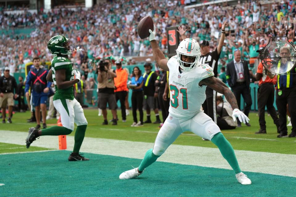 Dolphins running back Raheem Mostert celebrates a touchdown against the Jets with an emphatic spike.