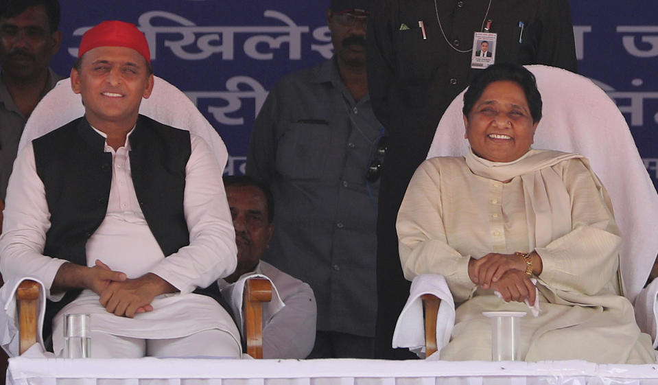 Bahujan Samaj Party (BSP) leader Mayawati, right, and Samajwadi Party (SP) leader Akhilesh Yadav, share the stage during an election rally in Deoband, Uttar Pradesh, India, Sunday, April 7, 2019. Political archrivals in India's most populous state rallied together Sunday, asking voters to support a new alliance created with the express purpose of defeating Prime Minister Narendra Modi's ruling Hindu nationalist Bharatiya Janata Party. (AP Photo/Altaf Qadri)