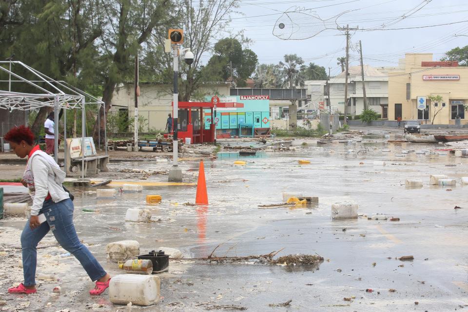 A woman walks through a debris-filled street in Bridgetown, Barbados after Hurricane Beryl blew through the island (REUTERS)