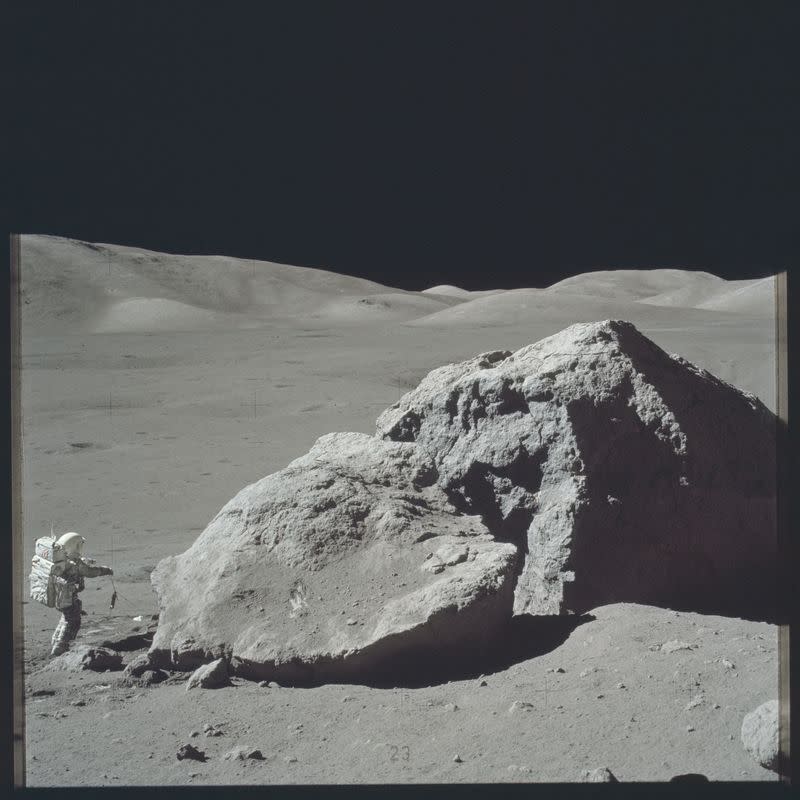 FILE PHOTO: Scientist-astronaut Harrison H. Schmitt is photographed standing next to a huge, split boulder during the third Apollo 17 extravehicular activity (EVA) on the moon during the Apollo 17 mission in this NASA handout photo