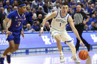 Kentucky's CJ Fredrick (1) drives as Kansas' Dajuan Harris Jr. (3) defends during the first half of an NCAA college basketball game in Lexington, Ky., Saturday, Jan. 28, 2023. (AP Photo/James Crisp)