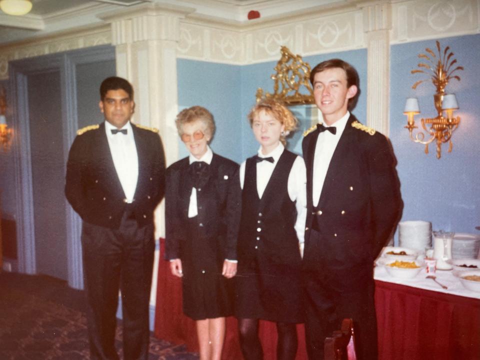 Four waitstaff standing in front of a breakfast table at a hotel