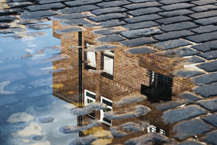 <span class="caption">The building of affordable housing has stalled under the Tories.</span> <span class="attribution"><a class="link " href="https://www.shutterstock.com/image-photo/cobblestone-reflection-house-puddle-after-rain-1098538682?src=e31965aa-d00d-4749-8505-360eb8f3f500-1-1" rel="nofollow noopener" target="_blank" data-ylk="slk:I Wei Huang/Shutterstock;elm:context_link;itc:0;sec:content-canvas">I Wei Huang/Shutterstock</a></span>