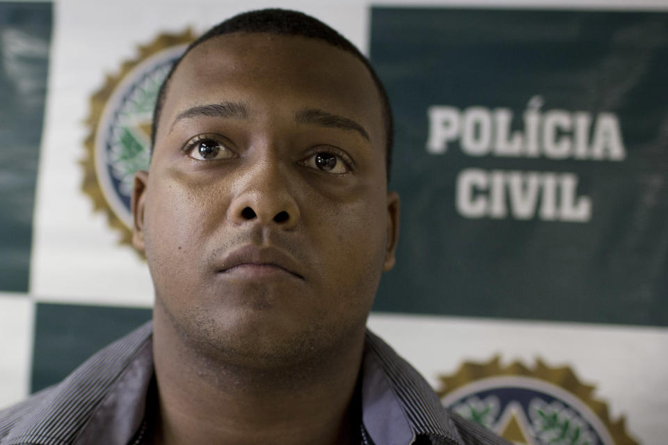 Suspect Carlos Armando Costa dos Santos is presented to the press at Special Police Unit for Tourism Support (DEAT) after being arrested for allegedly attacking tourists in Rio de Janeiro, Brazil, Tuesday, April 2, 2013. An American woman was gang raped and beaten aboard a public transport van while her French boyfriend was shackled, hit with a crowbar and forced to watch the attacks after the pair boarded the vehicle in Rio de Janeiro's showcase Copacabana beach neighborhood, police said. The attacks took place over six hours starting shortly after midnight on Saturday. (AP Photo/Felipe Dana)