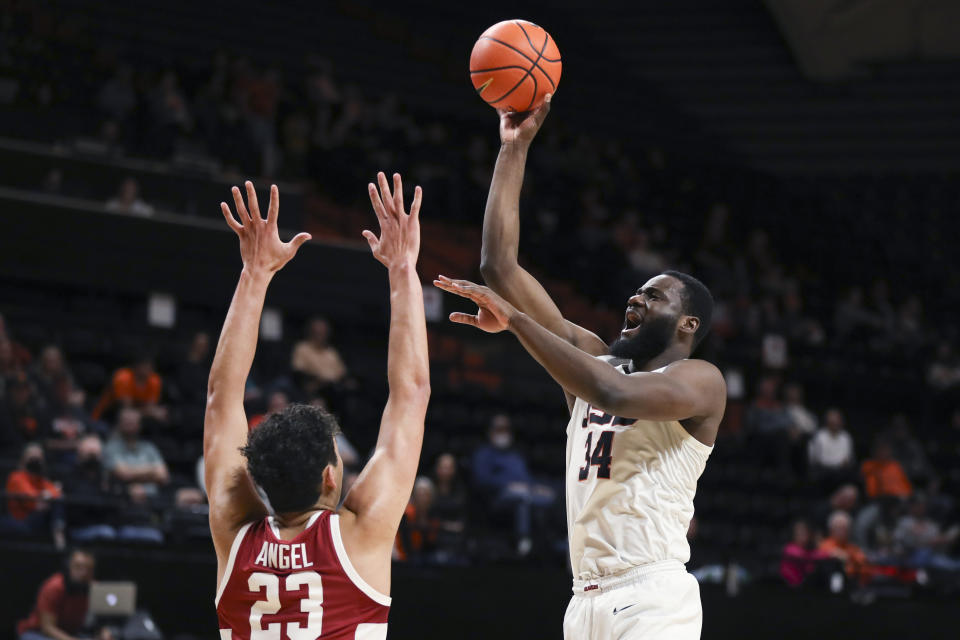 Oregon State forward Rodrigue Andela (34) shoots over Stanford forward Brandon Angel (23) during the first half of an NCAA college basketball game in Corvallis, Ore., Thursday, March 2, 2023. (AP Photo/Amanda Loman)