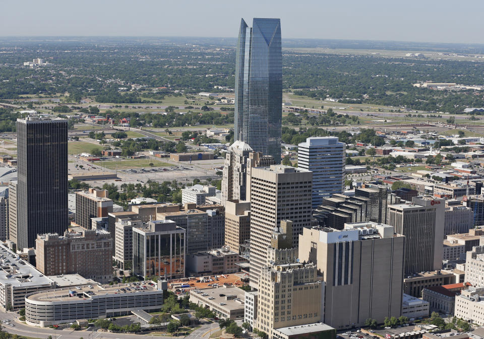 FILE - In this May 15, 2014 file photo, the Devon Energy Tower dwarfs other downtown buildings in Oklahoma City. The U.S. Department of Justice announced Monday, Sept. 27, 2021, that Oklahoma City-based Devon Energy Corporation and its affiliates have agreed to a $6.15 million settlement agreement with the federal government over allegations it underpaid royalties on federal leases. (AP Photo/Sue Ogrocki, File)