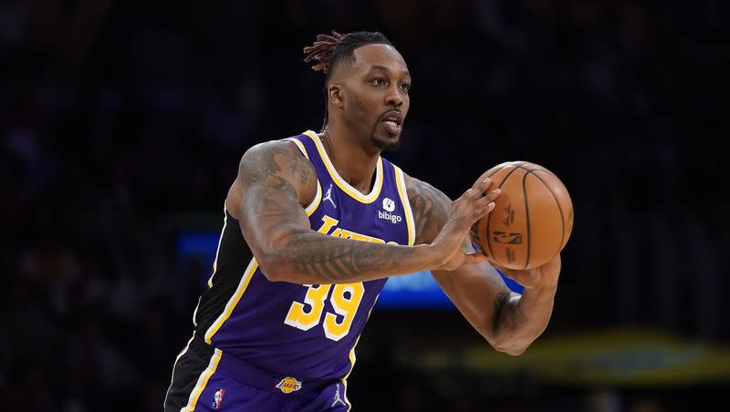 Los Angeles Lakers center Dwight Howard passes the ball during an NBA basketball game in 2022.