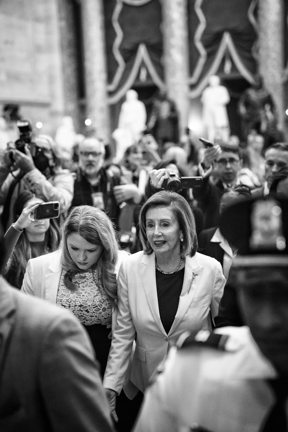 Surrounded by staff, security and journalists, Speaker of the House Nancy Pelosi, D-Calif., walks out of the House Chamber after announcing she would not be the Democratic leader in the 118th Congress at the U.S. Capitol on Nov. 17, 2022. (Frank Thorp V / NBC News)