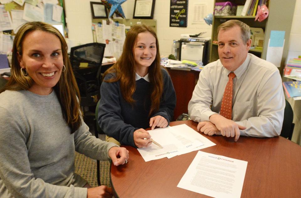 Morgan Cook, center, a sophomore at Norwich Technical High School, who wrote a $20,000 Voice4Change grant for the school, is joined by Principal Don Concascia and school social worker Jaime Miller Thursday.