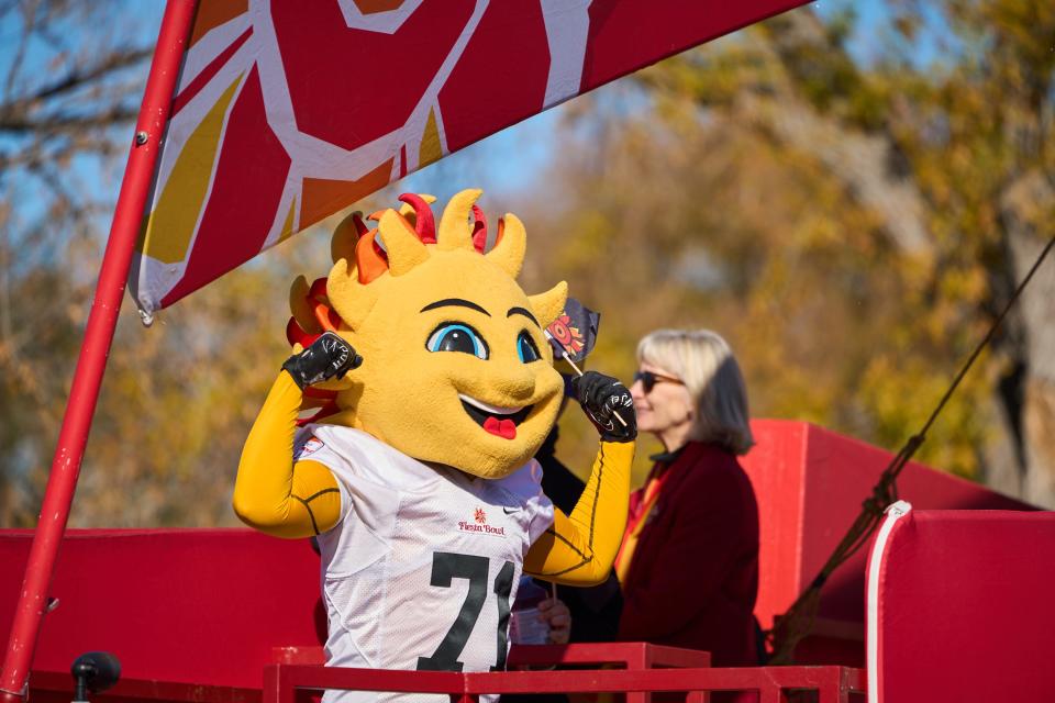 Dec 17, 2022; Phoenix, AZ, USA; Fiesta Bowl mascot, Spirit, flexes for the crowd during the Fiesta Bowl Parade in Phoenix on Saturday, Dec. 17, 2022. Mandatory Credit: Alex Gould/The Republic