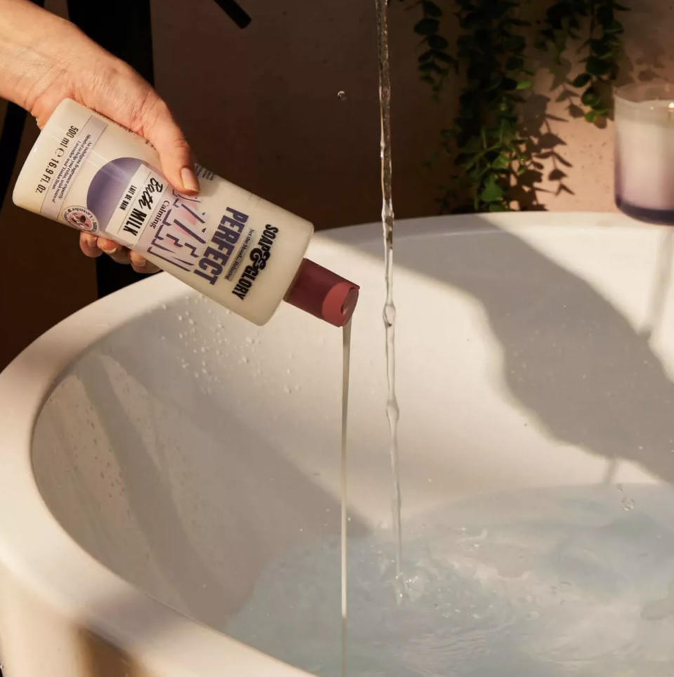 model pouring product into bath