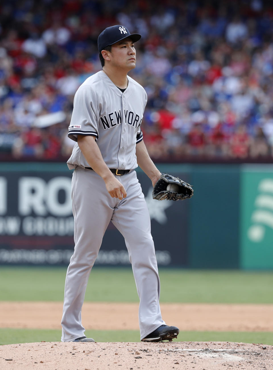 New York Yankees' Masahiro Tanaka walks back onto the mound as he works against the Texas Rangers in the third inning of a baseball game in Arlington, Texas, Sunday, Sept. 29, 2019. (AP Photo/Tony Gutierrez)