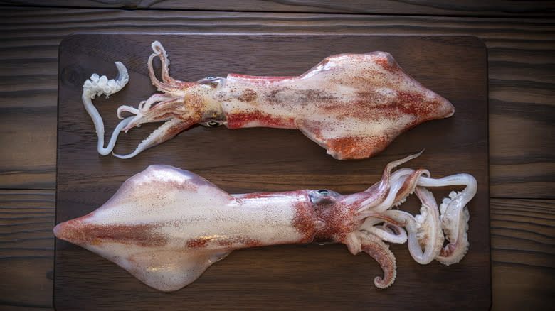 two squid on wooden board