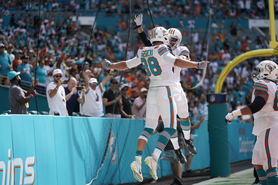 Miami Dolphins tight end Mike Gesicki (88), celebrates scoring a touchdown with teammate Miami Dolphins wide receiver Albert Wilson (2), during the second half of an NFL football game against the Indianapolis Colts, Sunday, Oct. 3, 2021, in Miami Gardens, Fla. (AP Photo/Lynne Sladky)